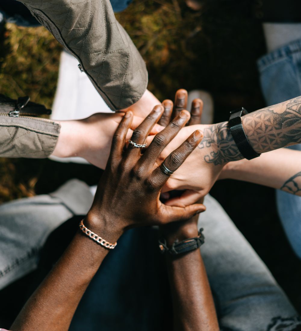 A circle of friends stacking their hands together